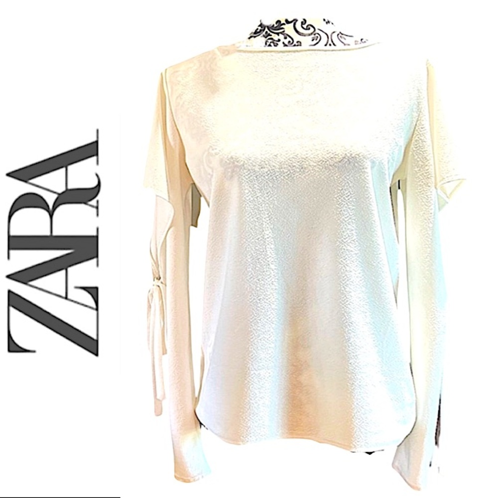 Zara.Fancy long sleeve blouse.Light cream in color.Open slits on arms.Size Small